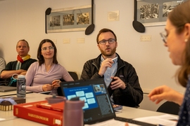Rich Nielsen, Volha Charnysh, Kevin Dorst, and Emily Richmond Pollock seated at a table, talking