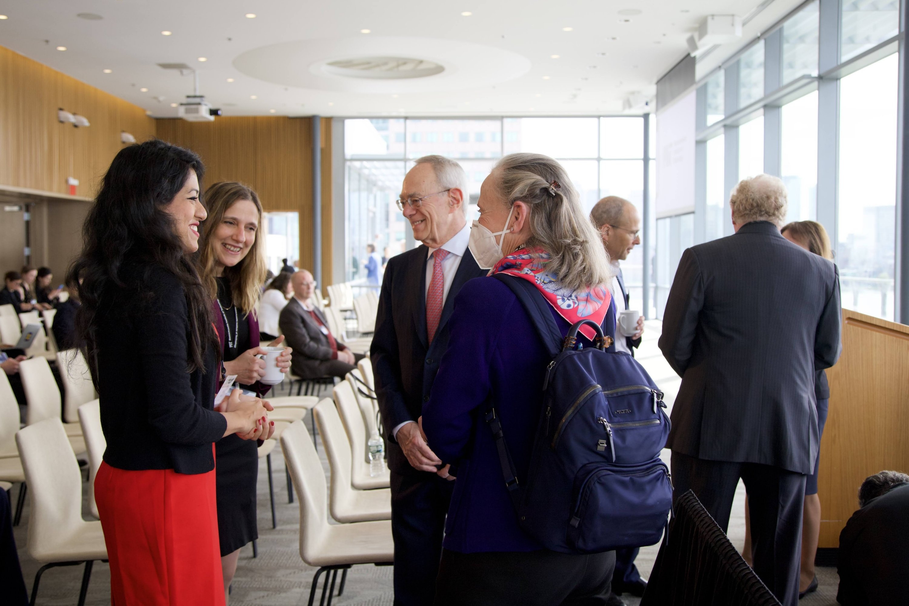 Left to right: Najat Khan, Janssen Research and Development chief data science officer and global head of strategy Najat Khan converses with Regina Barzilay, distinguished professor of AI and health at MIT and AI Cures co-chair; L. Rafael Reif, president of MIT; and Susan Hockfield, professor of neuroscience and MIT president emerita, at the MITxMGB AI Cures Conference.