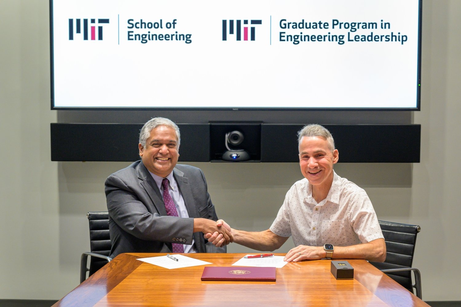 Dean Anantha Chandrakasan (left) shakes hands with Daniel J. Riccio at a gift-signing ceremony. Riccio has donated $10 million to expand MIT’s Graduate Engineering Leadership Program.