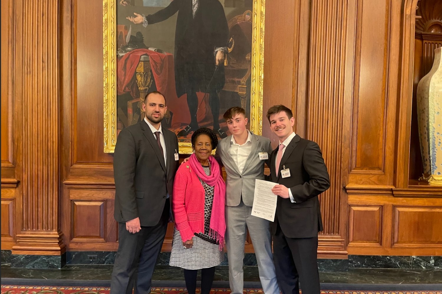 Three students with Representative Sheila Jackson Lee (second from left).