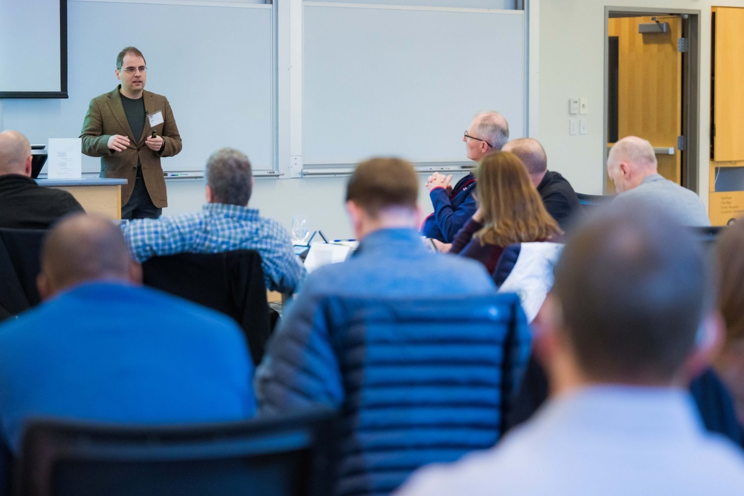 Professor Aleksander Madry delivers a lecture as part of the Artificial Intelligence for National Security Leaders (AI4NSL) program. The three-day program educates leaders who may not have a technical background on the basics of AI, machine learning, and data science, and how these topics intersect with national security. 