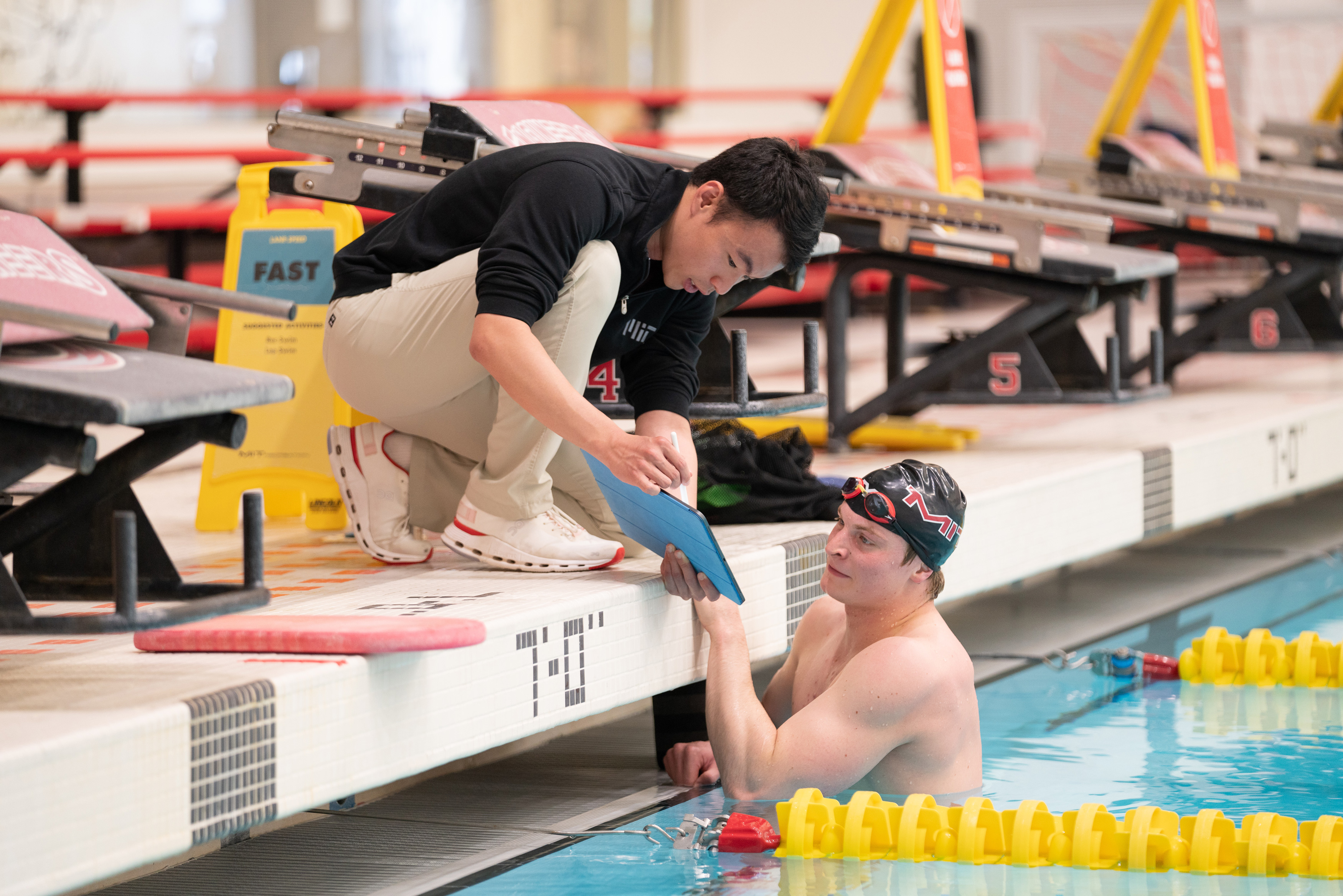 A former competitive swimmer, MIT graduate student Jerry Lu works to optimize the performance of elite athletes and their sporting organizations. Here, Jerry Lu, left, works with grad student Anatole Borisov to increase his performance in the pool.