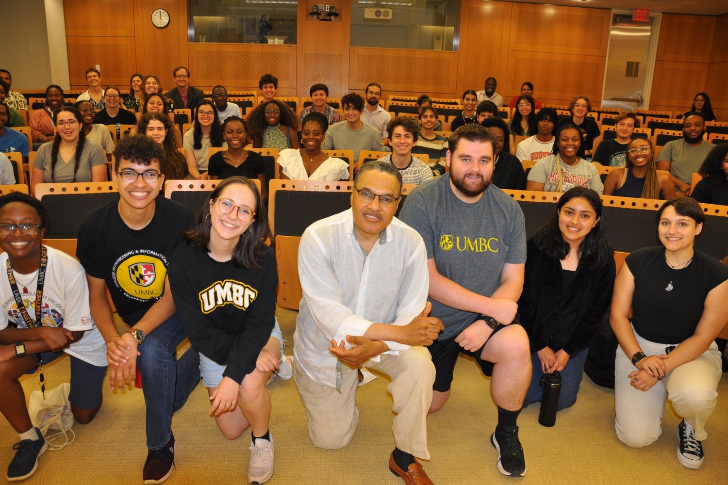 Freeman Hrabowski (center) posed for photos with a crowd of more than 50 before and after an informal event at MIT.