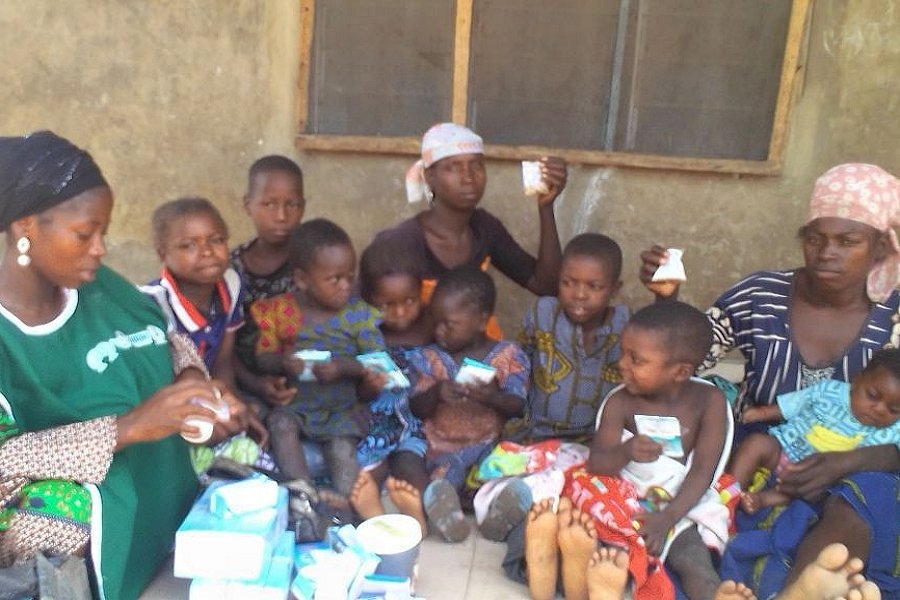 Mothers and children receive various vitamins for their household. A community health worker is also registering these individuals so they receive a continuum of care.