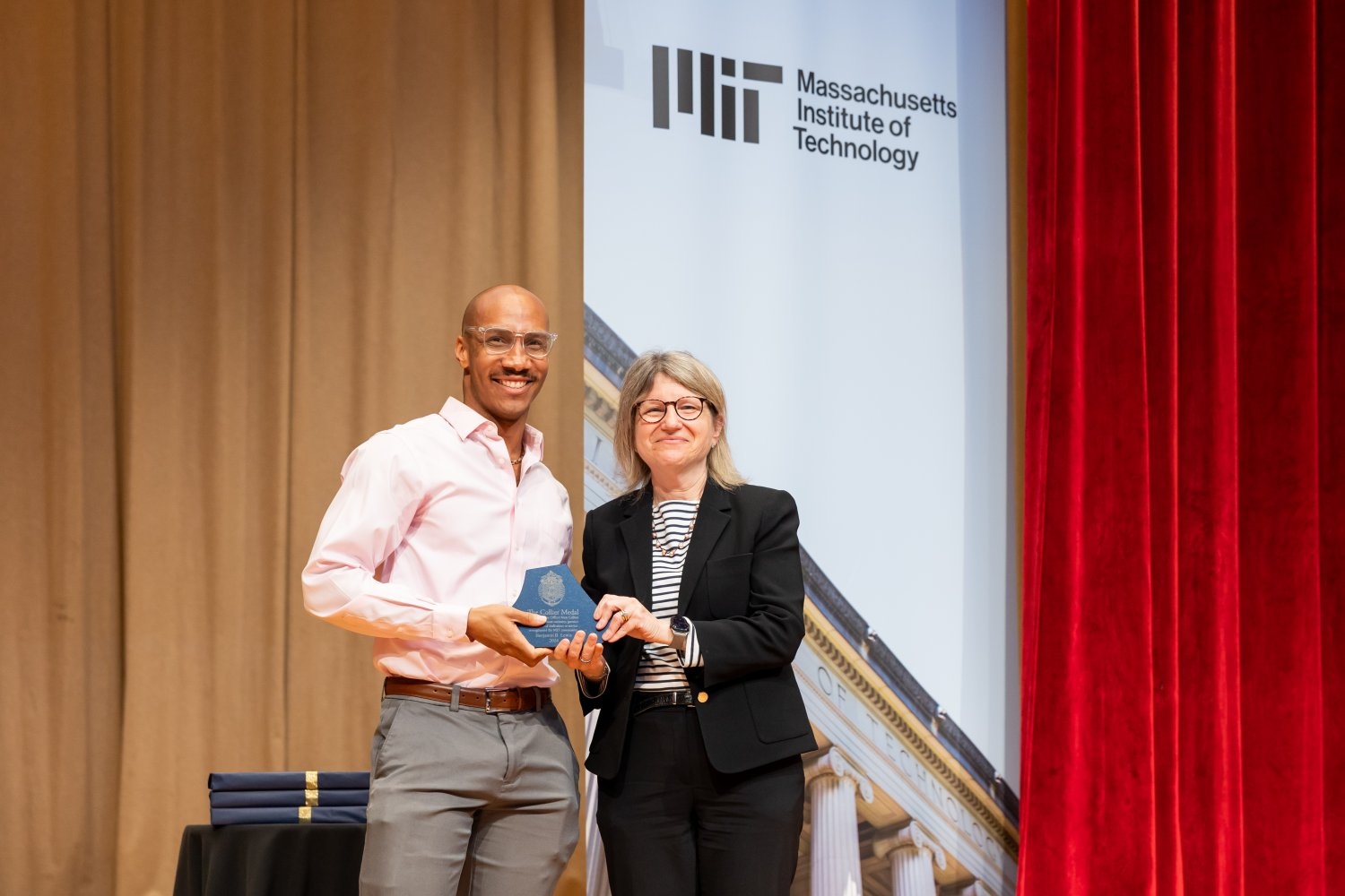 Benjamin Lewis (left), a graduate student in the Institute for Data, Systems and Society in the MIT Schwarzman College of Computing, was the 2024 recipient of the Collier Medal for his work as founder of the Cambridge branch of End Overdose, a nonprofit dedicated to reducing drug-related overdose deaths. MIT President Sally Kornbluth presented his award at the ceremony.