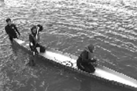 Sophomore Nat Grier steadies the canoe as graduate student Emily Dodd (left) and senior Stephanie Rosch, all in civil and environmental engineering, prepare to race in the 1998 ASCE Concrete Canoe Competition. The MI"T" canoe placed third in overall competition against 13 other canoes in the April 18-19 contest on Lake Champlain.