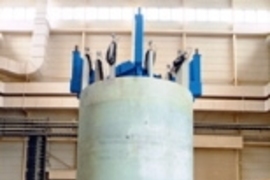 The inner module of a superconducting magnet built by the US team (left picture), with magnet team members including Rui Vieira of MIT (far left); and the outer module built by the Japanese team (center picture). At right is a cutaway drawing of the full assembly of both modules combined with the structure provided by the US.