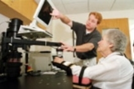 Dan Doherty, a physical therapist at Spaulding Rehabilitation Hospital, helps a patient work with MIT-Manus during her rehabilitation therapy following a stroke.