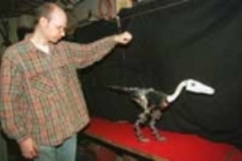 Pete Dilworth, a research scientist in the Artificial Intelligence Lab, with Troody the walking robotic dinosaur.