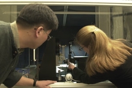 The new NanoMechanical Technology Laboratory is  equipped with state-of-the-art machines for the study of atomic and molecular  scale materials. Graduate students Yoonjoon Choi (left) and Krystyn Van Vliet  of materials science and engineering work with a nanoindenter that can probe and  measure the properties of materials' surfaces.