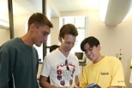Left to right: Julien Barrier of France, MIT's Martin Jonikas  of the United States and Alexandre Takeshi Ushima of Brazil collaborate on building  a robot from scratch using a tablet PC as part of the International Design Contest.