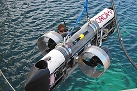 The six-foot-long ORCA-V has two main thrusters at the side and two vertical thrusters at the bow and stern. There are two main dry compartments in the sub; the top one contains a computer that controls the sub, while the bottom one contains the batteries and the motor drivers.