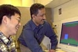 MIT graduate student Jung Kim and senior research scientist Mandayam A. Srinivasan demonstrate a transatlantic touch.