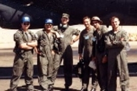 William John Hecht Jr., center, a captain in the U.S. Air Force during the Gulf War, poses with crew in front of their B-52 bomber.