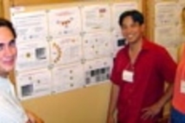 Sawyer B. Fuller (S.B. 2000, S.M. 2003); Brian Chow, a Ph.D. student in the Media Lab; and postdoctoral associate Andrea Lomander of the Center for Biomedical Engineering review posters about scientific research displayed at the conference center.