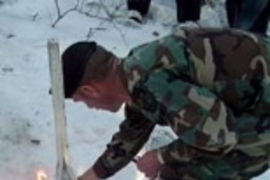 An Army staff sergeant demonstrates how to start a fire using the magnesium from a snowshoe.
