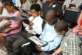 From left: Tiona Edwards, Krystian Eaglehorse, Dwayne James and Troy Jimenez look over their certificates and group photos at the final program of the MIT STEM summer program.
