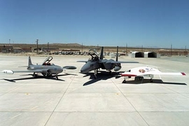 A test of the MIT manned-to-unmanned guidance system at Edwards Air Force Base used, from left, a Lockheed T-33 trainer fighter jet and a Boeing F-15 fighter jet. Eventually an unmanned aerial vehicle, right, will be used in place of the trainer jet.