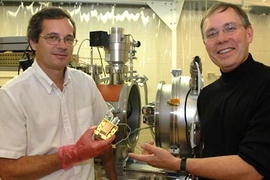 MIT research scientists Steve Kissel, left, and Mark Bautz hold up a copy of the core element used in their X-ray camera.