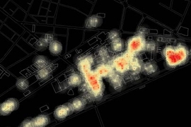 A screenshot from an animation showing the changing patterns of  wireless Internet activity during 24 hours on the MIT campus. Red indicates a large number of users per access point, black a small number.