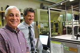 Professors Robert Cohen and Michael Rubner pose in Rubner's lab with equipment they use to try to mimic the watermaking abilities of the Namib Desert beetle.