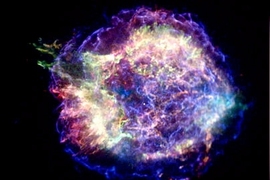 A supernova remnant acts like a relativistic pinball machine by accelerating electrons to enormous energies. The blue, wispy arcs in this image of Cassiopeia A, the youngest supernova remnant in the Milky Way, show where the acceleration is taking place in an expanding shock wave generated by the explosion. The red and green regions show material from the destroyed star that has been heated to mil...