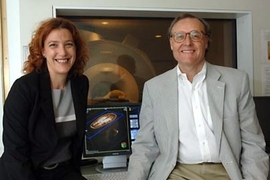 Noa Ofen, a post-doc in MIT's McGovern Institute for Brain Research and Department of Brain and Cognitive Sciences, and Professor John Gabrieli, co-director of the Clinical Research Center in the same department and associate member of the McGovern Institute, sit by a monitor displaying an image of a child's brain, which was taken usng the MRI scanning machine behind them.