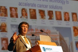 Tyler Jacks, Director of the David H. Koch Institute for Integrative Cancer Research, gave the introduction at the 2008 Koch Institute Symposium entitled Nanotechnology and Cancer: The Power of Small Science, held at Kresge Auditorium on Friday, June 24. Behind him are pixtures of faculty members who comprise the Koch Institute. <a onclick="MM_openBrWindow('cancersym1-enlarged.html','','width=509,...