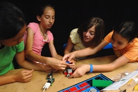 Students from the O'Maley Middle School in Gloucester, MA put together "insect robots" and learn how to make them move with light and touch using computer sensors at the Edgerton Center at MIT. From left are Qiana Curcuru, Kelly Foster, Casie Quinn and Justina Catarino.