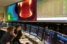 From the control room, graduate students Rachael McDermott and Eric Edlund perform experiments on the Alcator C-Mod tokamak to support their thesis work.