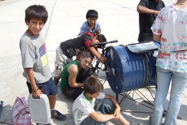 MIT students and residents of Ventanilla, Peru work on the bicilavadora, a novel, inexpensive bike/washing machine.