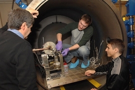 Department of Aeronautics and Astronautics graduate student Taylor Matlock, center, principal research scientist Oleg V. Batishchev, left, and Dan Stiurca, junior in electrical engineering and computer science, right, work on adjusting a prototype of a new plasma rocket.