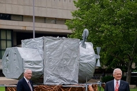 Neil Armstrong (left) and Buzz Aldrin ScD '63 stand beside a replica of their lunar landing module that was recently built by MIT students as a "hack" that appeared on top of the great dome.