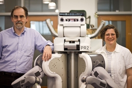 MIT computer scientists Tomás Lozano-Pérez and Leslie Kaelbling with the Willow Garage PR2 robot.