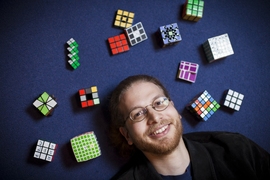 Erik Demaine's collection of Rubik's-cube-type puzzles includes cubes with five, six, and seven squares to a row, as well as one of the original cubes, signed by its inventor.