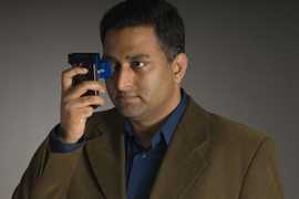 Ramesh Raskar takes an eye test using one of his team’s clip-on test devices.