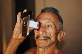 A man named Francisco takes an eye test in Brazil.