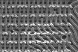 This electron microscope image shows two layers of nanowires produced through the MIT team's self-assembly process, showing how deviations in the pattern and connections between the layers can be included in the design.