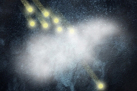 An artist's conception shows how any number of incoming photons (top) can be absorbed by a cloud of ultra-cold atoms (center), tuned so that only one single photon can pass through at a time. Being able to produce a controlled beam of single photons has been a goal of research toward creating quantum devices.