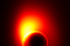 This image, created using computer models, shows how the extreme gravity of the black hole in M87 distorts the appearance of the jet near the event horizon. Part of the radiation from the jet is bent by gravity into a ring that is known as the 'shadow' of the black hole.