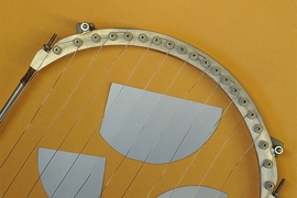 Pieces of a silicon wafer (in gray), used for solar cells or computer chips, can be coated or "passivated" using a vapor deposition process, in which the wires shown here are heated to vaporize polymer materials which then are deposited to coat the surface.