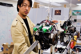 Assistant Professor Sangbae Kim demonstrates the 70-pound 'cheetah' robot designed at MIT.