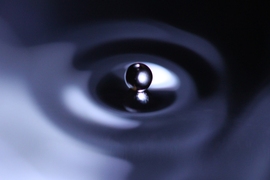 In an experimental fluid-dynamic system that can reproduce quantum-mechanical phenomena, a drop of fluid striking the surface of a fluid bath produces waves that in turn propel the droplet across the bath.