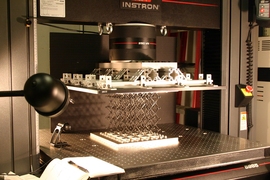 In the lab, a sample of the cellular composite material is prepared for testing of its strength properties. 