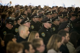 Members of the MIT Police, colleagues of the late Sean Collier, received a standing ovation as they filed in to take part in Friday's tribute ceremony.