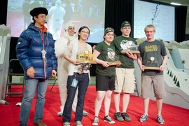 Class co-teachers Sangbae Kim and Amos Winter celebrate with top winners of the competition displaying their trophies. From left, the students are Clare Zhang (first place), Emma Steinhardt (fourth place), Joshua Born (second place), and Jacob Wachlin (third place, and high-scorer in the contest).