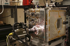The experimental chamber setup is seen from the front, with high speed camera looking into the chamber from the left.