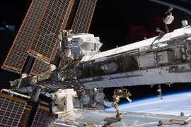The starboard truss of the International Space Station while Space Shuttle Endeavour docked with the station. The newly installed Alpha Magnetic Spectrometer (AMS) is visible at center left.