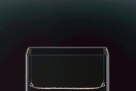 A physical model of the liquid metal battery at room temperature, in a glass container. The bottom layer is the positive electrode. In the real battery this is an alloy of antimony and lead, represented here by mercury. The middle layer is the electrolyte — in reality, a mixed molten salt; here, a solution of salt in water. The top layer is the current collector of the negative electrode, a meta...