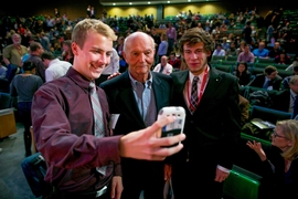 Astronaut Michael Collins (middle) poses for photos with members of the audience during the MIT AeroAstro Centennial Symposium.